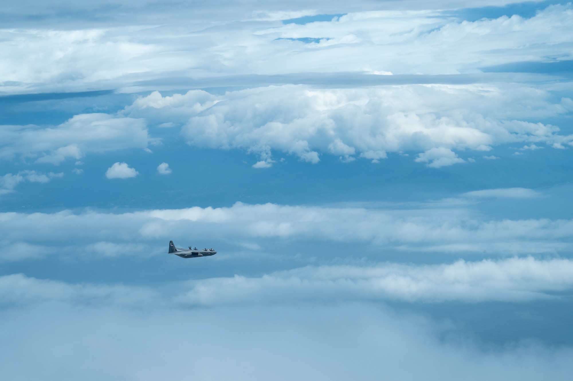 An aircraft flies in the distance near mount Fuji.