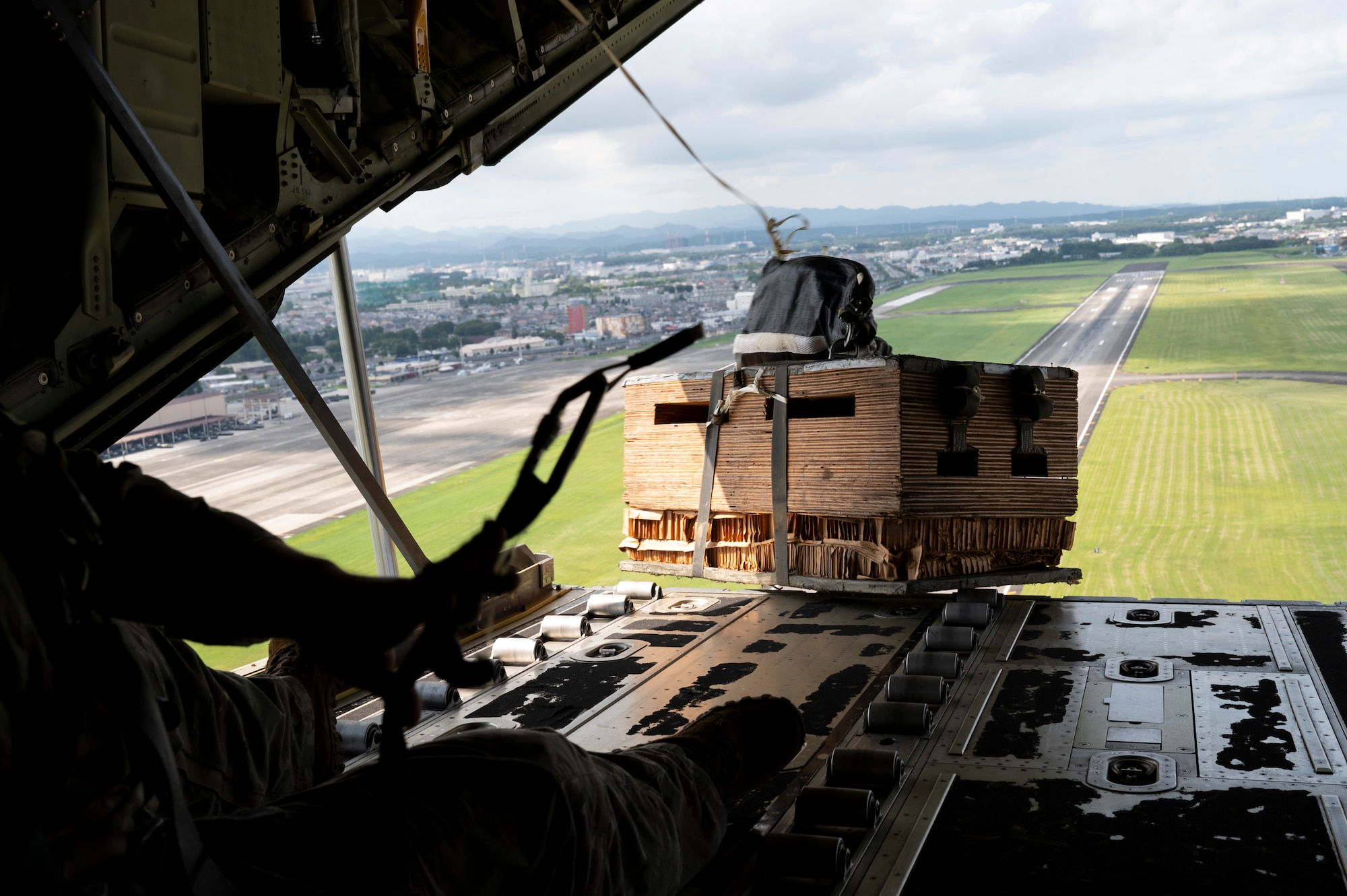 Cargo is launched out of the cargo ramp of an aircraft.