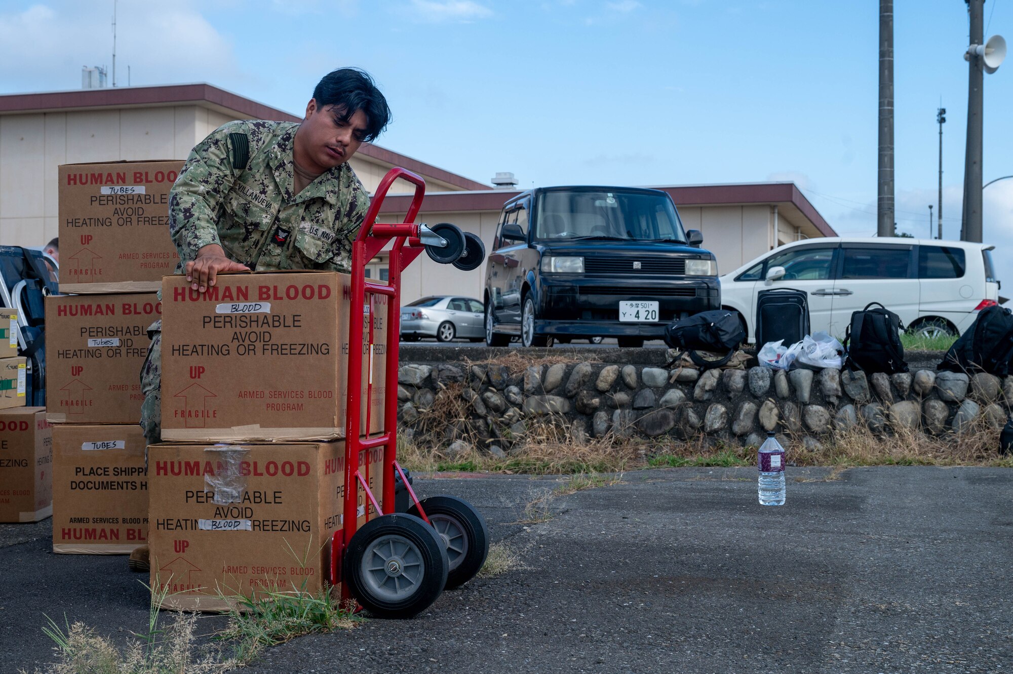 Service member loads boxes onto dolly.