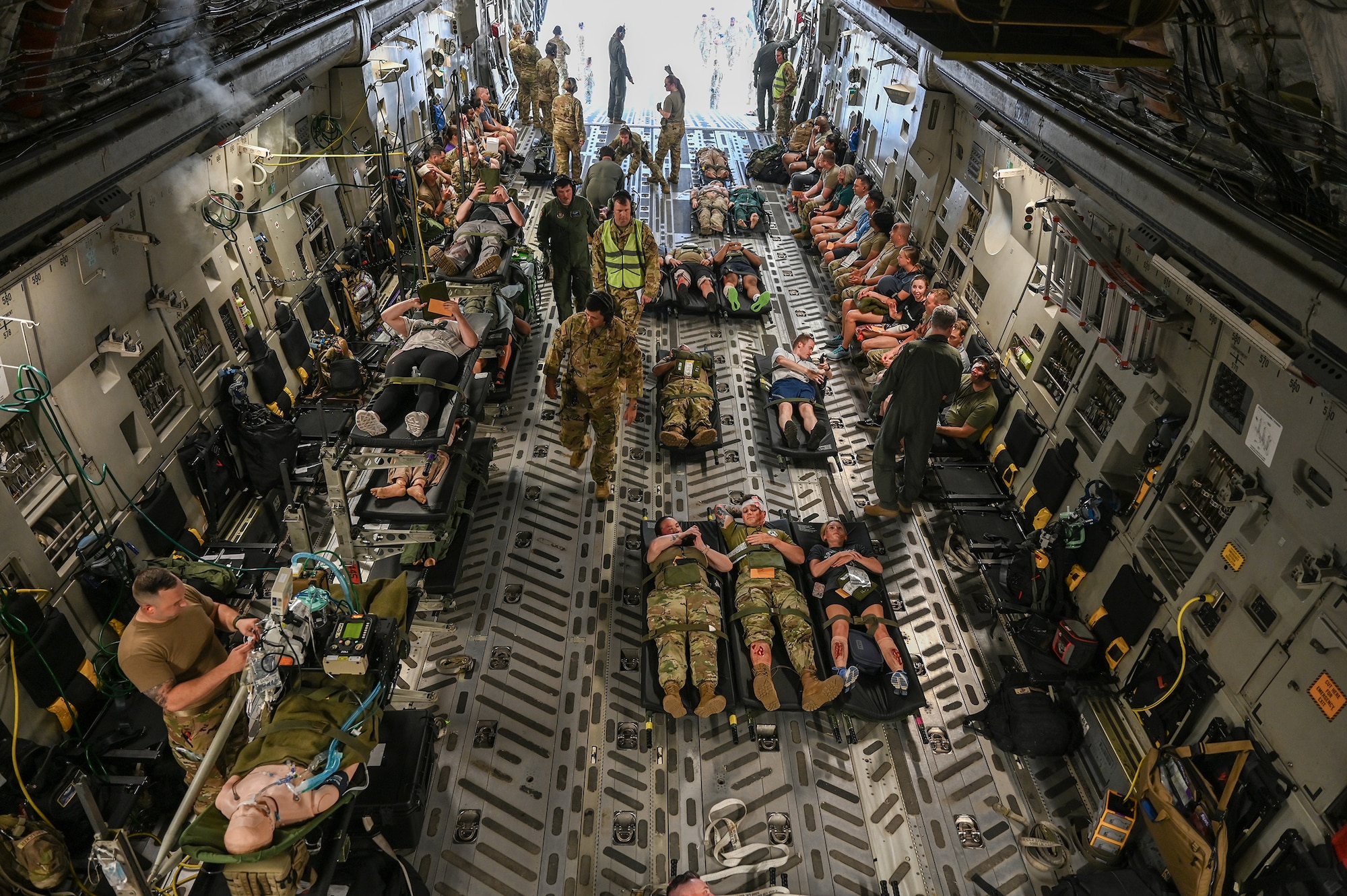 A 445th Airlift Wing C-17 Globemaster III is loaded with mock patients during a multi-unit mass casualty exercise at Wright-Patterson Air Force Base, Ohio, Aug. 3, 2024. The exercise included members of the 445th Aeromedical Staging, Aerospace Medicine and Aeromedical Evacuation Squadrons. (U.S. Air Force photo/Master Sgt. Patrick O’Reilly)