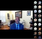 Video screenshot of a man wearing a blue suit and icons of other attendees.