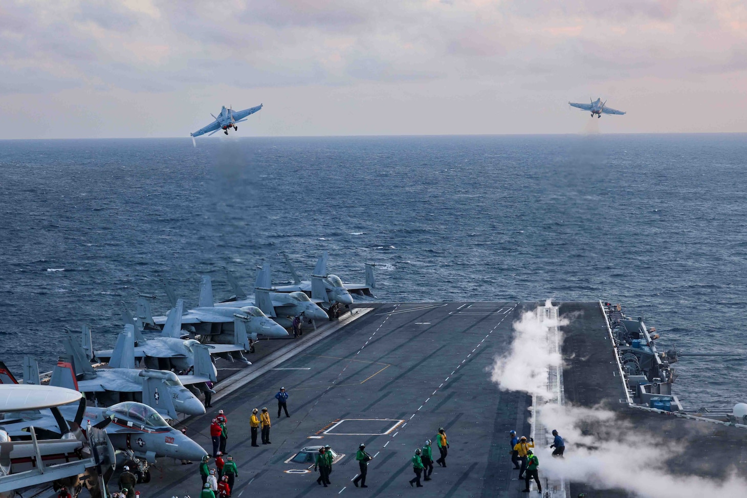 An F/A-18E Super Hornet, attached to the “Sunliners” of Strike Fighter Squadron (VFA) 81, left, and an F/A-18F Super Hornet, attached to the “Red Rippers” of Strike Fighter Squadron (VFA) 11,  launch from the flight deck of the Nimitz-class aircraft carrier USS Harry S. Truman (CVN 75), Aug. 2.