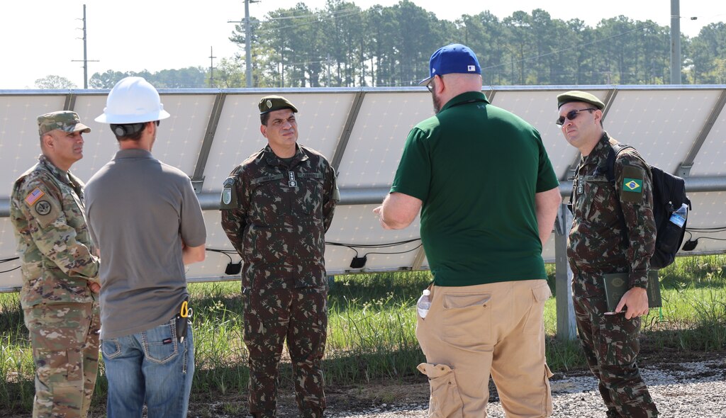 Two Brazilian officers looking at solar panels