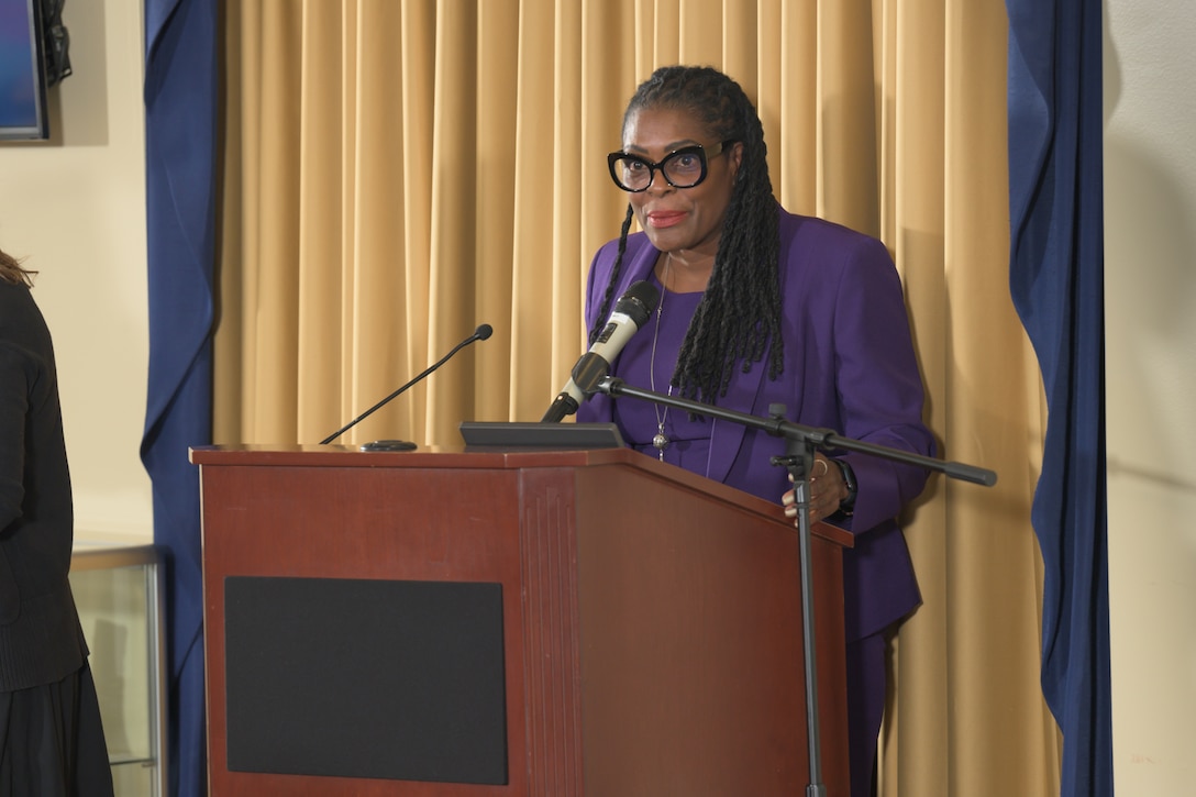 Carrie Register-Haley, the founder and CEO of Revelation of Investment Coaching, speaks during the McNamara Headquarters Complex Women’s Equality Day observance