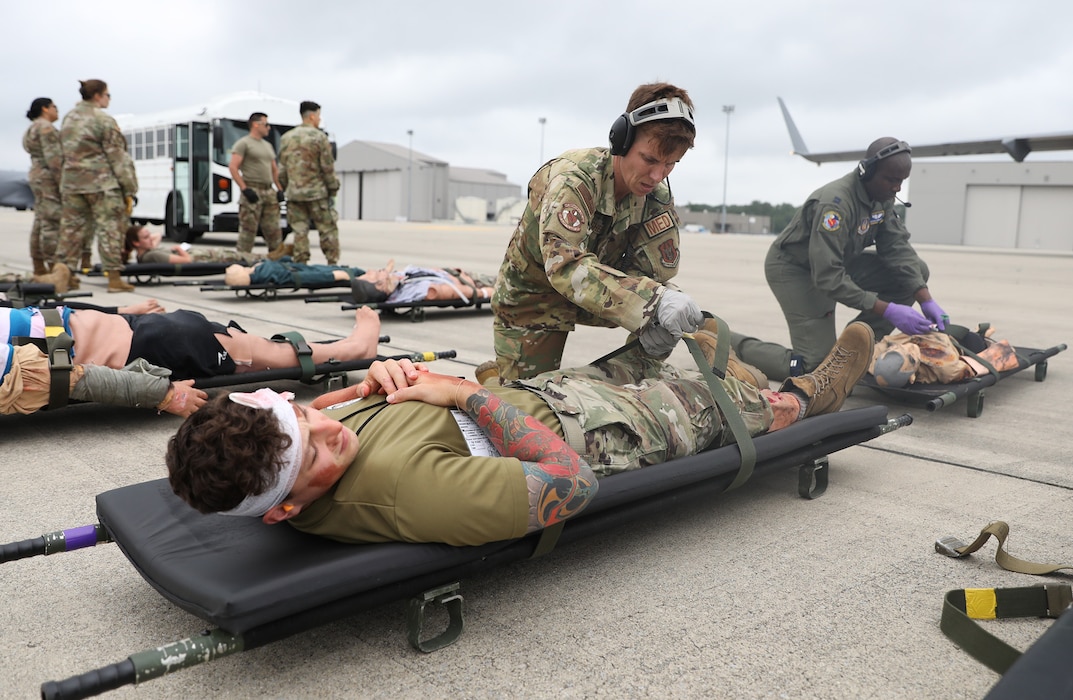 Senior Airman Andrea Plaugher, 445th Aeromedical Evacuation Squadron medical technician, triages mock patients prior to loading them onto a C-17 Globemaster III during a multi-unit mass casualty exercise at Wright-Patterson Air Force Base, Ohio, Aug. 3, 2024. The exercise included members of the 445th Aeromedical Staging Squadron, Aerospace Medicine Squadron and AES. (U.S. Air Force photo/Senior Airman Angela Jackson)