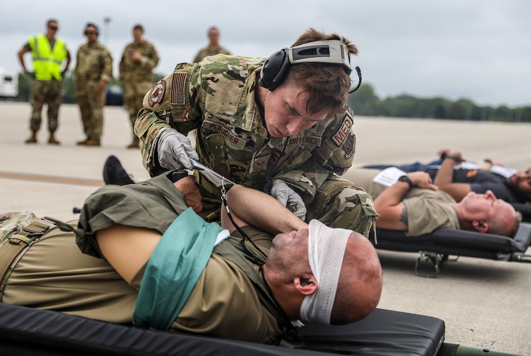 Senior Airman Andrea Plaugher, 445th Aeromedical Evacuation Squadron medical technician, triages mock patients prior to loading them onto a C-17 Globemaster III during a multi-unit mass casualty exercise at Wright-Patterson Air Force Base, Ohio, Aug. 3, 2024. The exercise included members of the 445th Aeromedical Staging Squadron, Aerospace Medicine Squadron and AES. (U.S. Air Force photo/Senior Airman Angela Jackson)