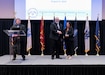 Katie Ellis-Warfield, deputy director of Public and Congressional Affairs at U.S. Army Medical Logistics Command, receives her certificate for completing the Defense Civilian Emerging Leader Program (DCELP) during a graduation ceremony Aug. 9 at the National Center for Employee Development in Norman, Oklahoma. Pictured with Ellis-Warfield is Jim Buchman, DOD chief learning officer/director of talent development, Defense Civilian Personnel Advisory Service.