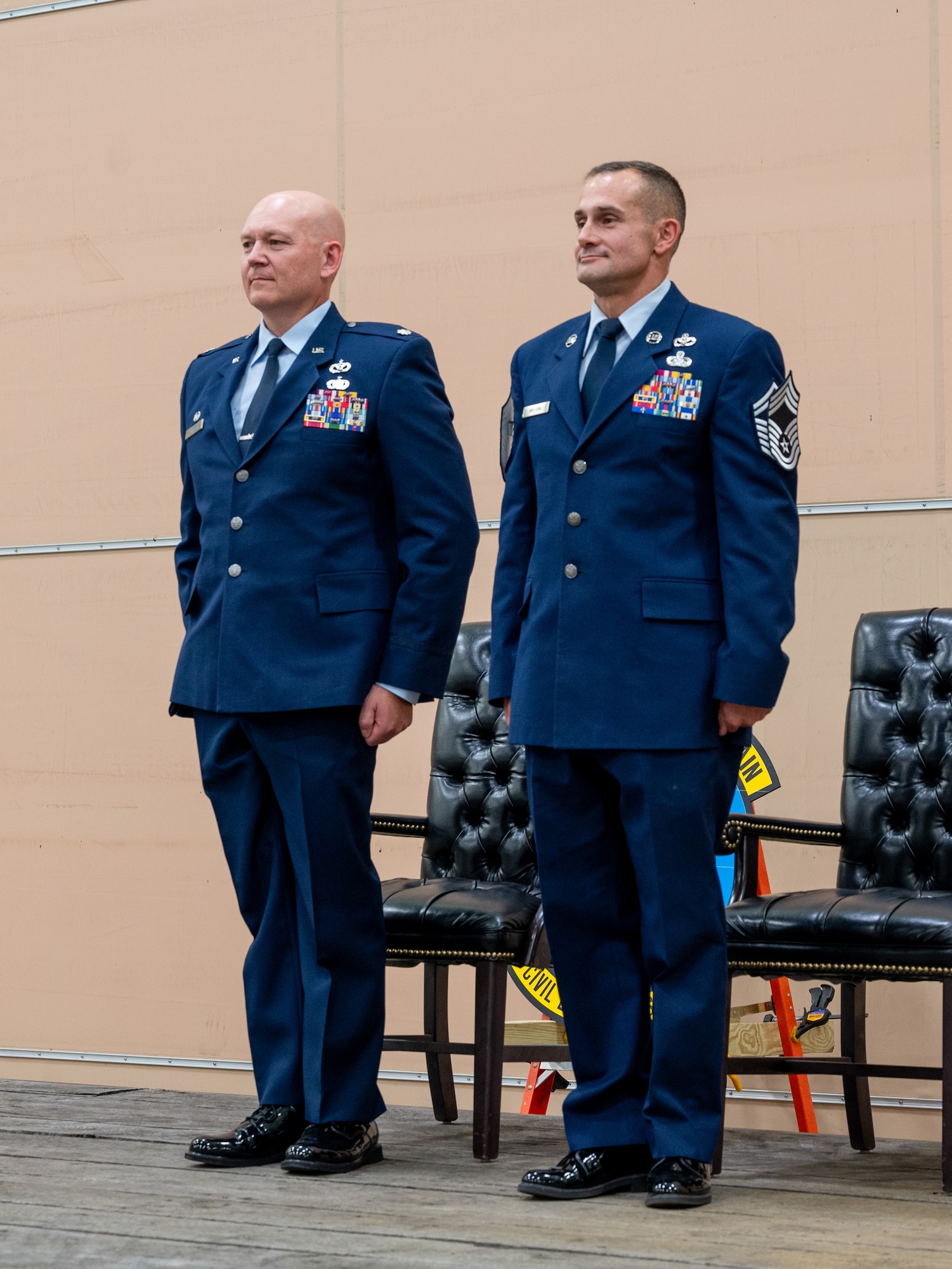 Two Airmen stand at attention.
