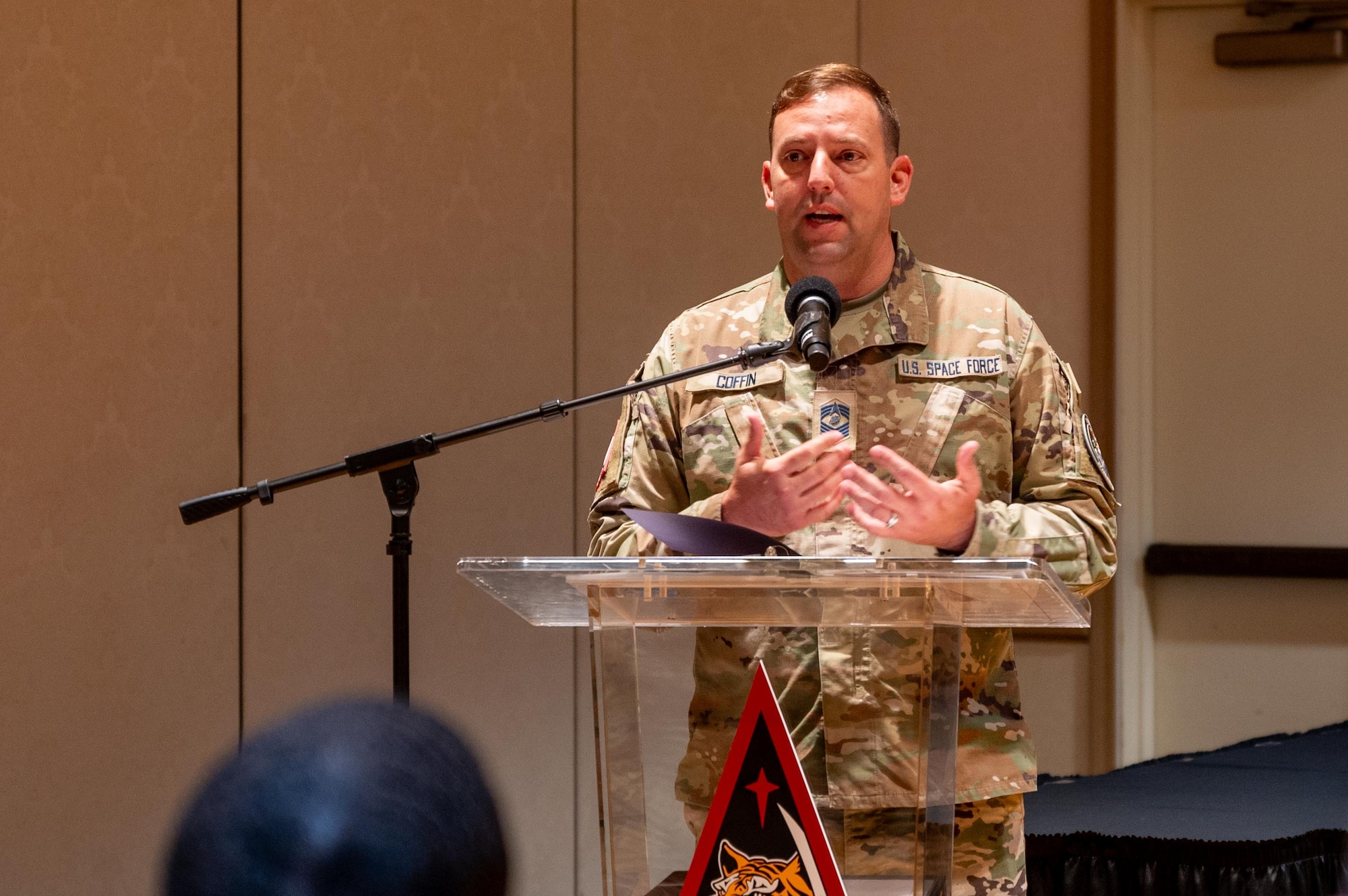 A senior military soldier speaks at a podium during an official ceremony.
