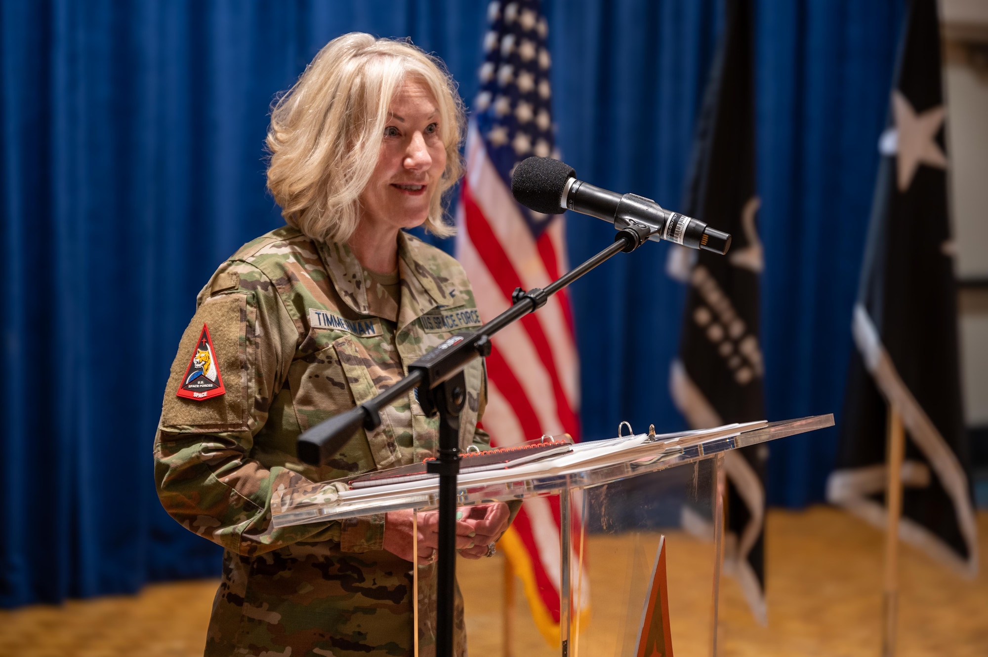 A senior military soldier speaks at a podium during an official ceremony.