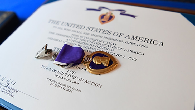 Image of tow Airmen saluting.