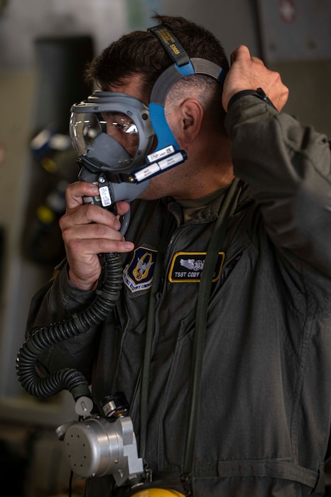 a portrait photo of a U.S. Airman in a C-17. He wearing an oxygen mask.