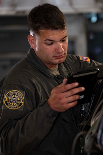 a portrait photo of a U.S. Airman on the flight line.