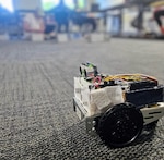 Robot “ART’’ waits as students program their robots to complete navigation challenge.