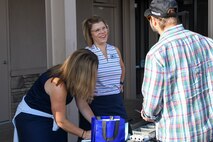 Kellie Sheeran, member of the Beale Military Liaison Council (BMLC), talks with competitors at the annual Patriotic Golf Tournament in Marysville, California, Aug. 23, 2024.