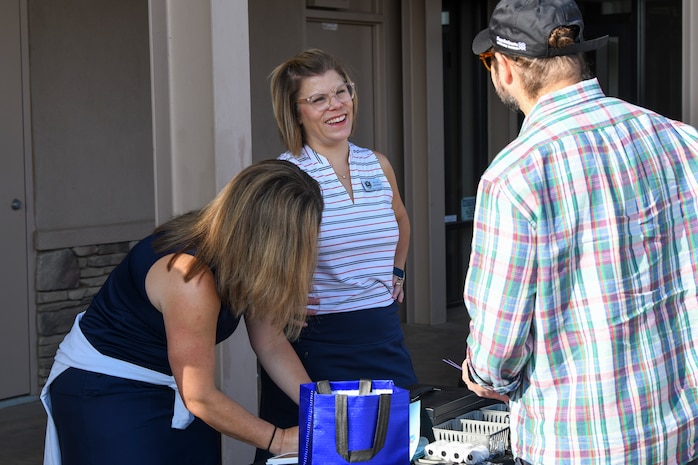 Kellie Sheeran, member of the Beale Military Liaison Council (BMLC), talks with competitors at the annual Patriotic Golf Tournament in Marysville, California, Aug. 23, 2024.