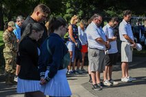 Golfers and members of Beale Air Force Base bow their heads during the opening invocation at the annual Patriotic Golf Tournament in Marysville, California, Aug. 23, 2024.