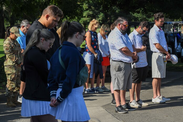 Golfers and members of Beale Air Force Base bow their heads during the opening invocation at the annual Patriotic Golf Tournament in Marysville, California, Aug. 23, 2024.