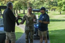 U.S. Air Force Chief Master Sgt. Steven Creek, 9th Reconnaissance Wing command chief, talks to John Schwab, 9th Reconnaissance Wing chief of community relations, at the annual Patriotic Golf Tournament in Marysville, California, Aug. 23, 2024.