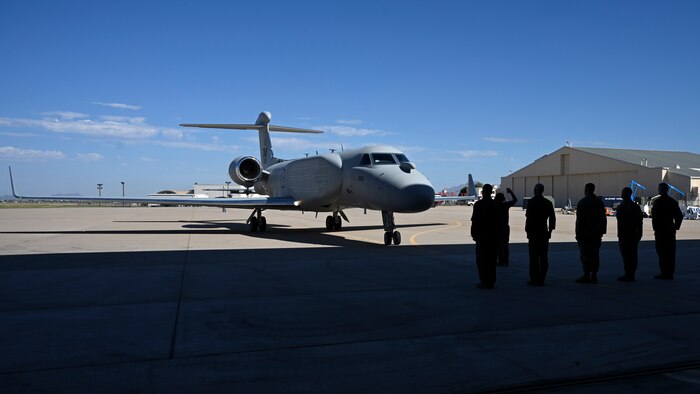 Leaders from the 55th Wing, 55th Electronic Combat Group, and 43rd Electronic Combat Squadron stand ready to receive Air Combat Command’s first EA-37B Compass Call aircraft