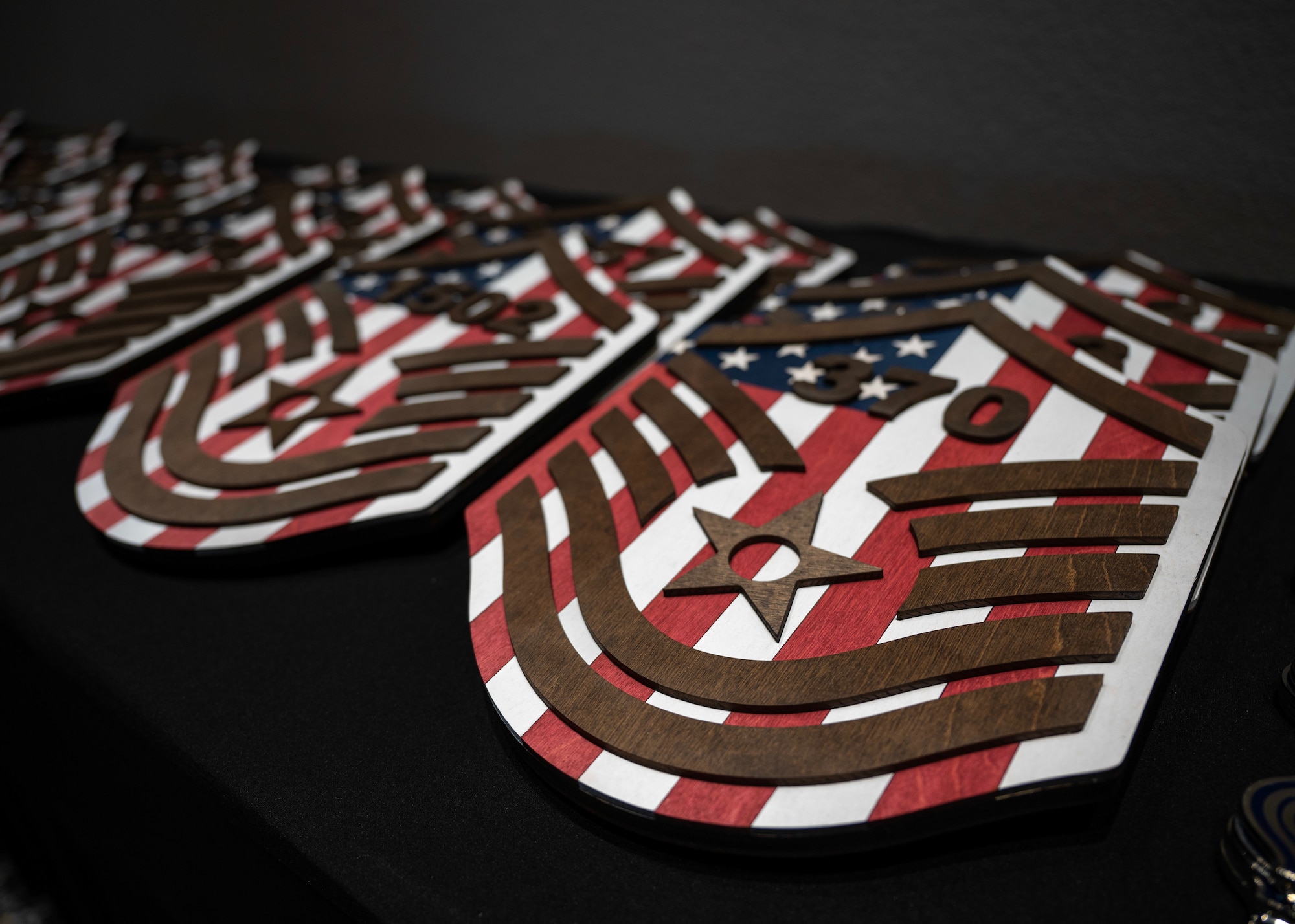 Master Sgt. plaques are displayed before the Senior Noncommissioned Officer Induction Ceremony, at the Powell Event Center, Goodfellow Air Force Base, Texas, Aug. 23, 2024. Receiving Master Sergeant plaques during the induction ceremony symbolized the recognition of the inductees' leadership, dedication, and transition into a higher level of responsibility within the ranks. (U.S. Air Force photo by Senior Airman Sarah Williams)