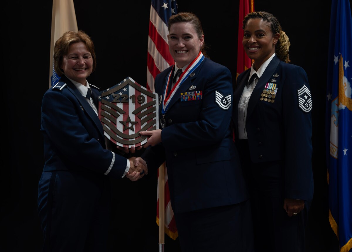 U.S. Air Force Col. Angelina Maguinness, 17th Training Wing commander, Chief Master Sgt. Khamillia Washington, 17th Training Wing command chief, and Master Sgt. Select Kristine McCarthy, 313th Training Squadron international training section chief, pose for a photo at the Senior Noncommissioned Officer Induction Ceremony, at the Powell Event Center, Goodfellow Air Force Base, Texas, Aug. 23, 2024. McCarthy and other inductees were celebrated and recognized for their achievements. (U.S. Air Force photo by Senior Airman Sarah Williams)