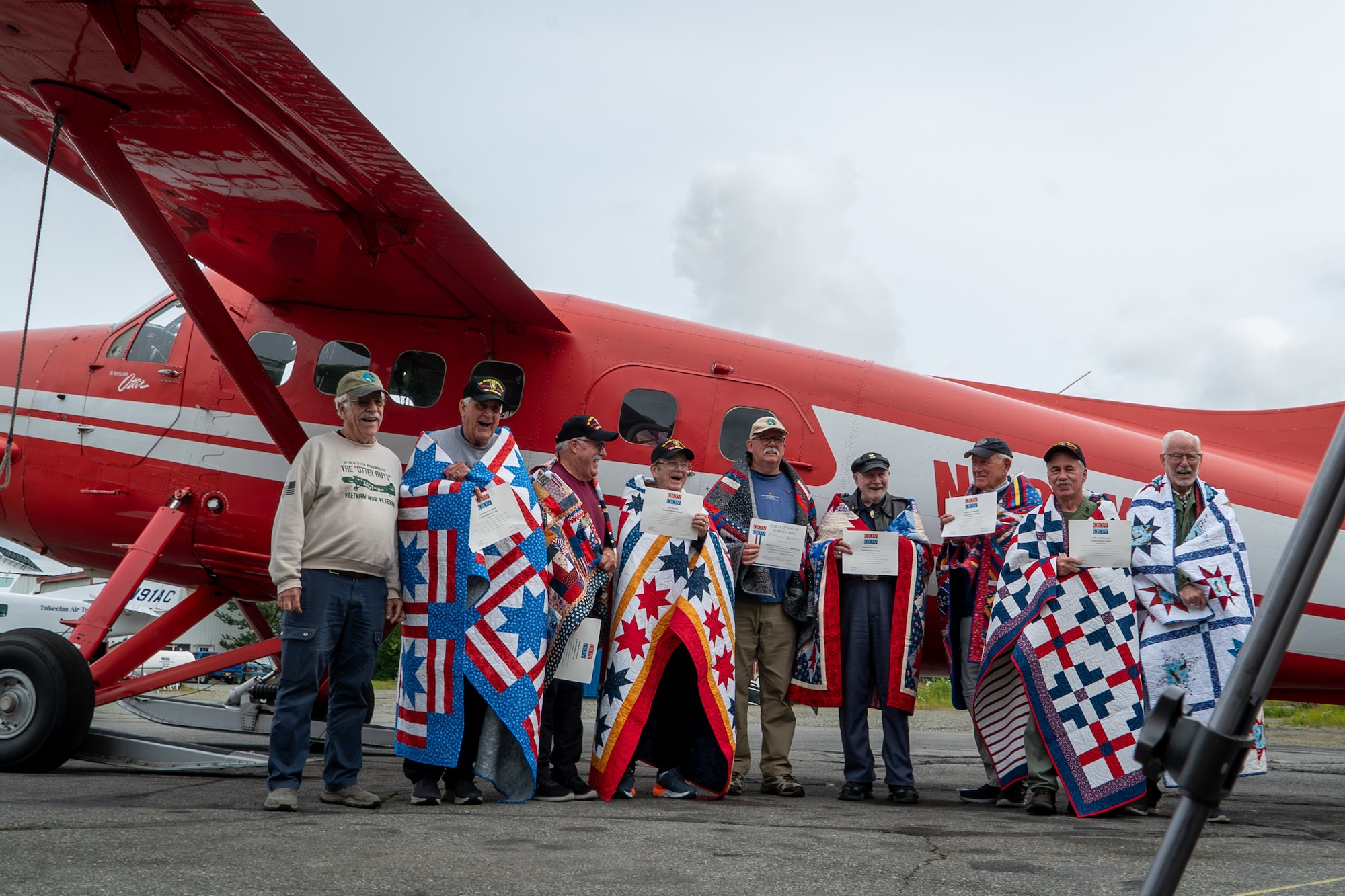 A group of Vietnam War veterans pose for a picture in front of a De Havilland DHC-3 Otter, in Talkeetna, Alaska, Aug. 12, 2024.