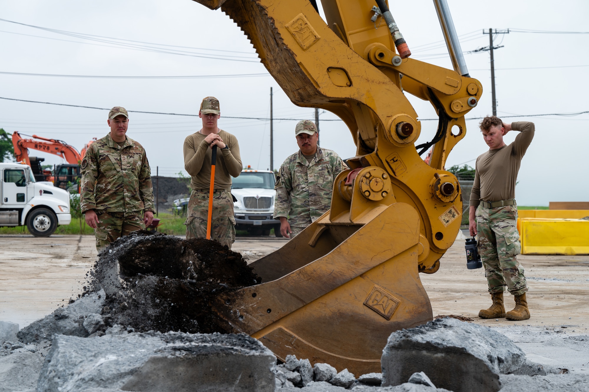 Airmen assigned to the 374th Civil Engineer Squadron oversee the excavation phase during a Rapid Airfield Damage Recovery exercise at Yokota Air Base, Japan.