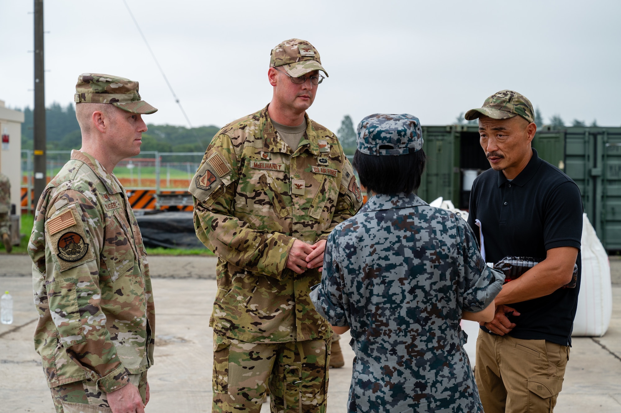 U.S. Air Force Col. Richard McElhaney, 374th Airlift Wing commander, speaks to Japan Air Self-Defense Force Col. Yoshino Kitagawa, Central Air Civil Engineering commander, during a Rapid Airfield Damage Recovery exercise at Yokota Air Base, Japan.