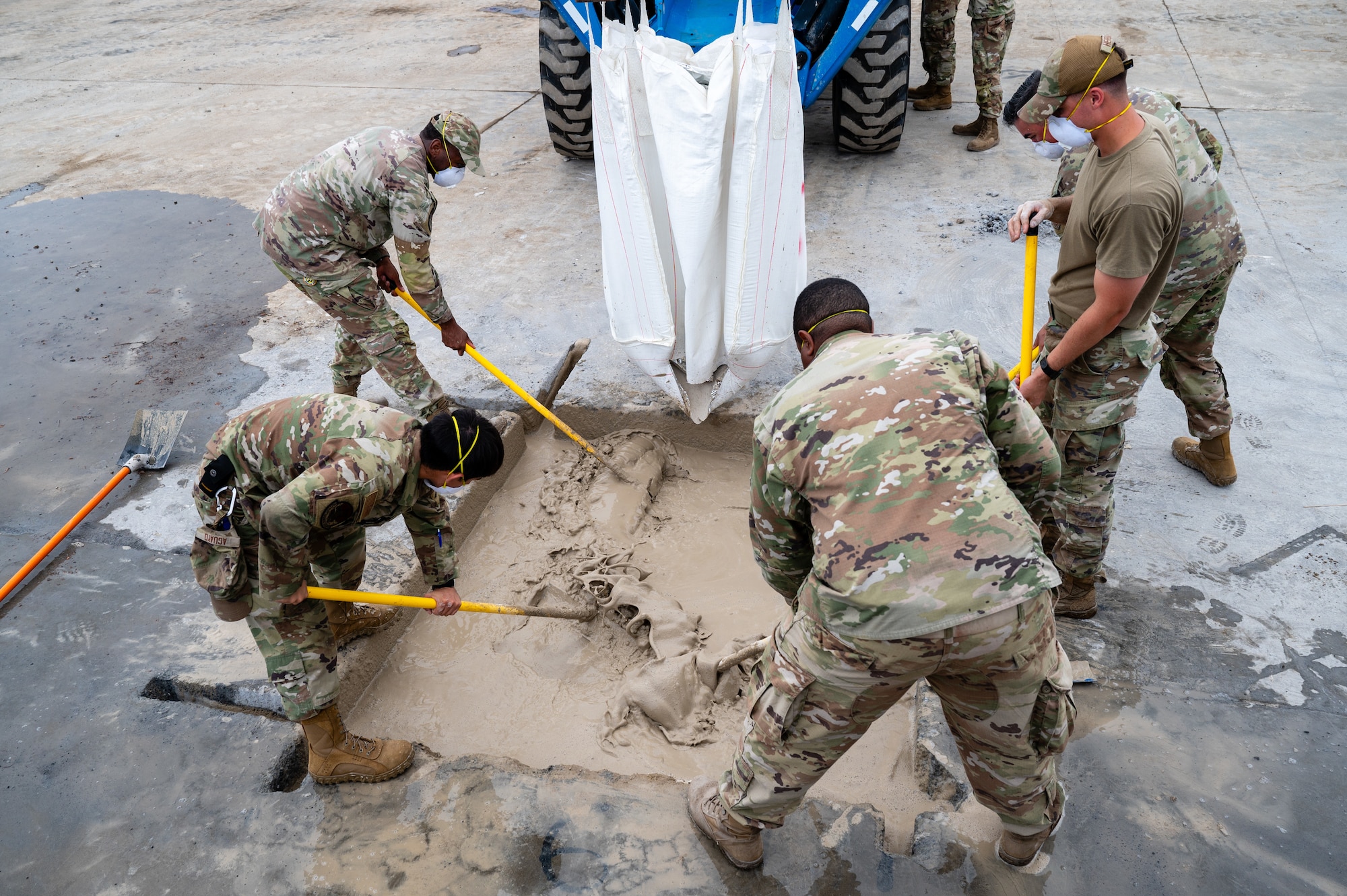 Airmen assigned to the 374th Civil Engineer Squadron mix flowable fill with water during a Rapid Airfield Damage Recovery exercise at Yokota Air Base, Japan.