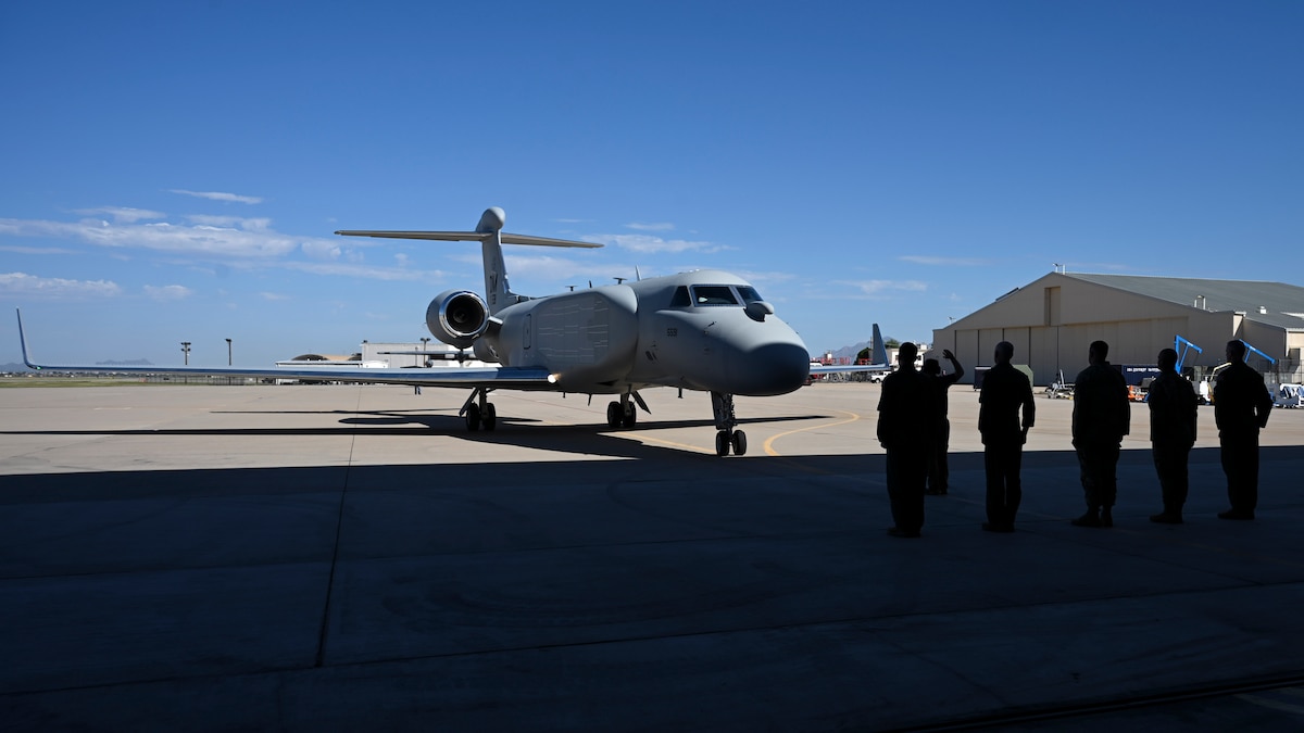Leaders from the 55th Wing, 55th Electronic Combat Group, and 43rd Electronic Combat Squadron stand ready to receive Air Combat Command’s first EA-37B Compass Call aircraft