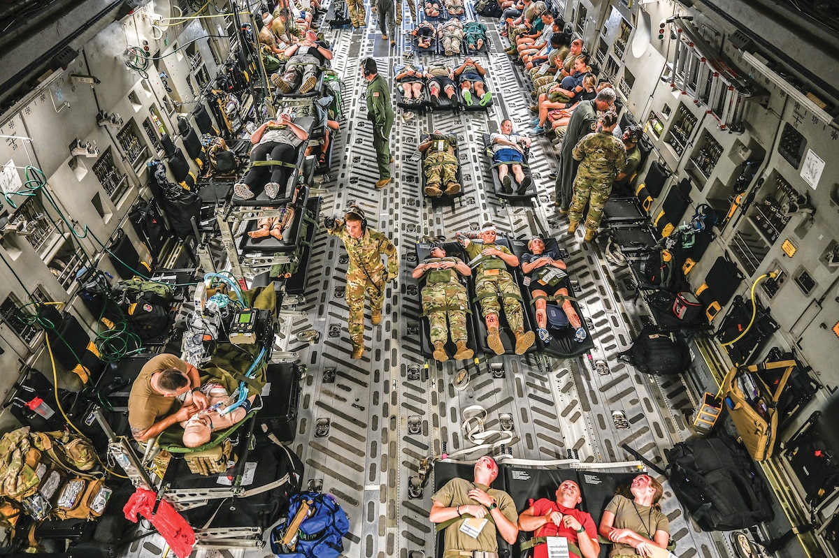 A 445th Airlift Wing C-17 Globemaster III is loaded with mock patients during a multi-unit mass casualty exercise at Wright-Patterson Air Force Base, Ohio, Aug. 3, 2024. The exercise included members of the 445th Aeromedical Staging, Aerospace Medicine and Aeromedical Evacuation Squadrons. (U.S. Air Force photo/Master Sgt. Patrick O’Reilly)