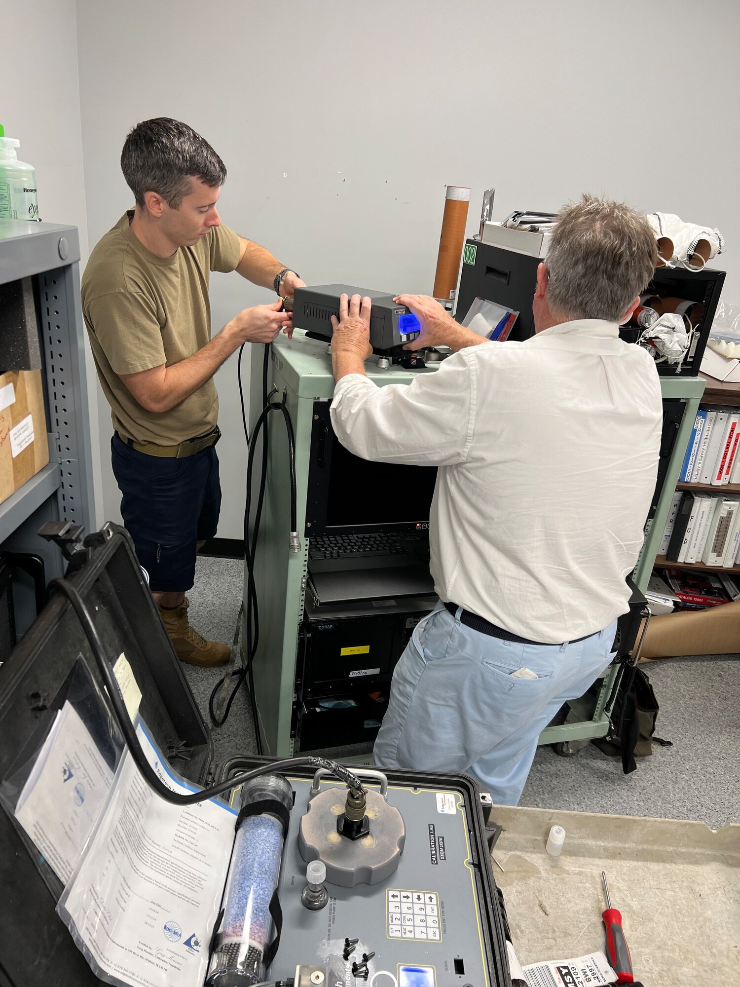 Contractor trains military members while updating equipment.