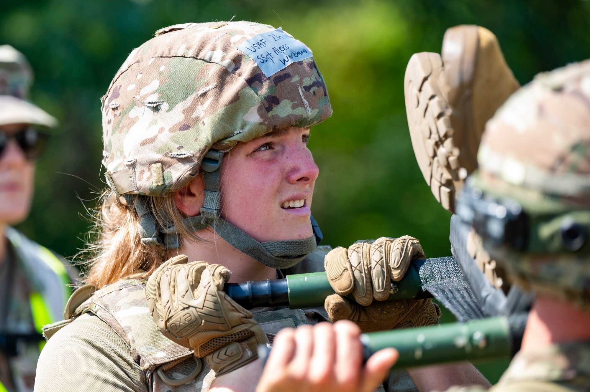 Staff Sgt. Alexis Workman hoists a simulated patient on a litter during a 4-person carry