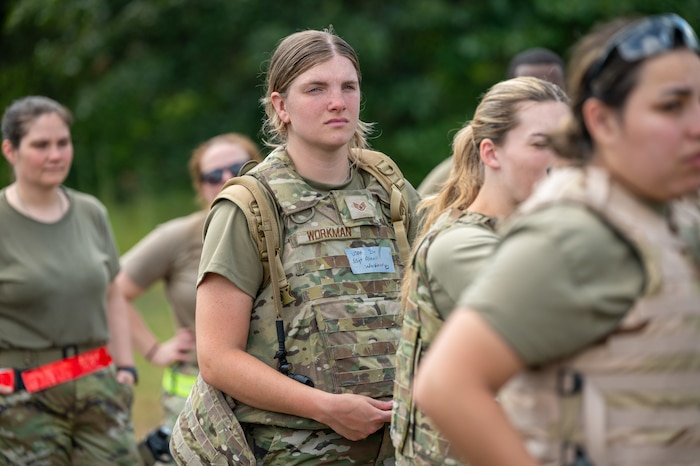 Staff Sgt. Alexis Workman listens intently to instructions provided amidst a group of other medical personnel