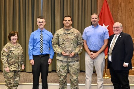 Brig. Gen. Laura McHugh, left, deputy adjutant general-Army, Pennsylvania National Guard, poses with members of the state public affairs office after presenting them with the U.S. Army Keith L. Ware Public Affairs Organization of the Year award Aug. 20, 2024, at Fort Indiantown Gap, Pa. (U.S. Army National Guard photo by Spc. Jessica Barb)