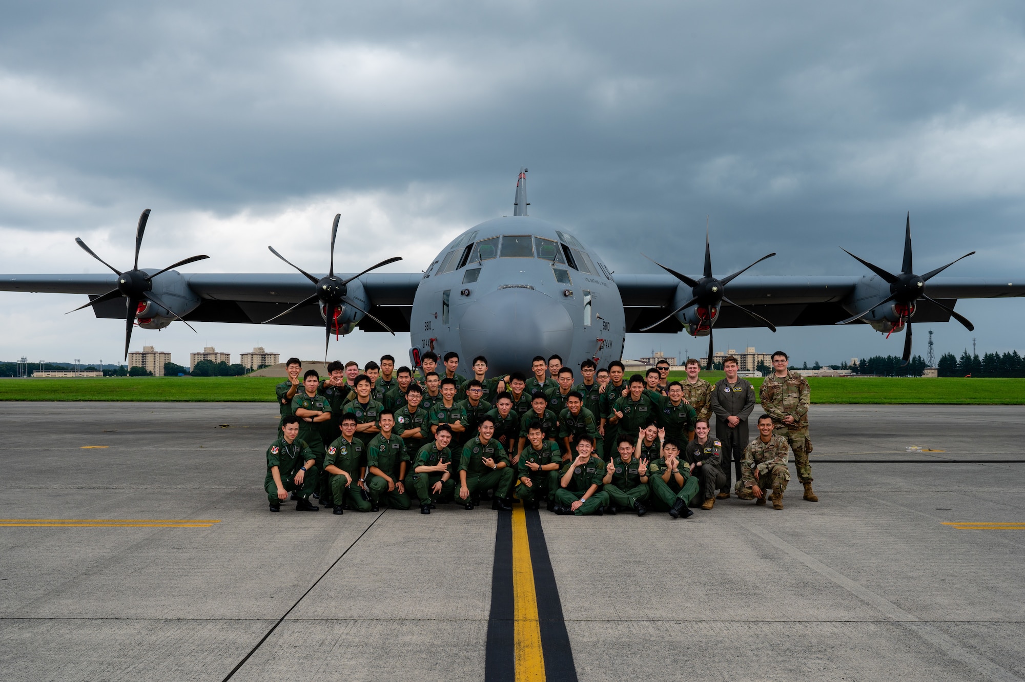 Japan Air Self-Defense Force Officer Candidate School students and members of the 374th Airlift Wing pose for a photo in front of a C-130J Super Hercules assigned to the 36th Airlift Squadron during a tour at Yokota Air Base, Japan.