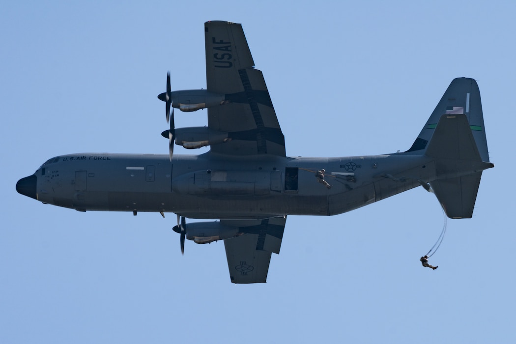 Paratroopers leap from a flying C-130