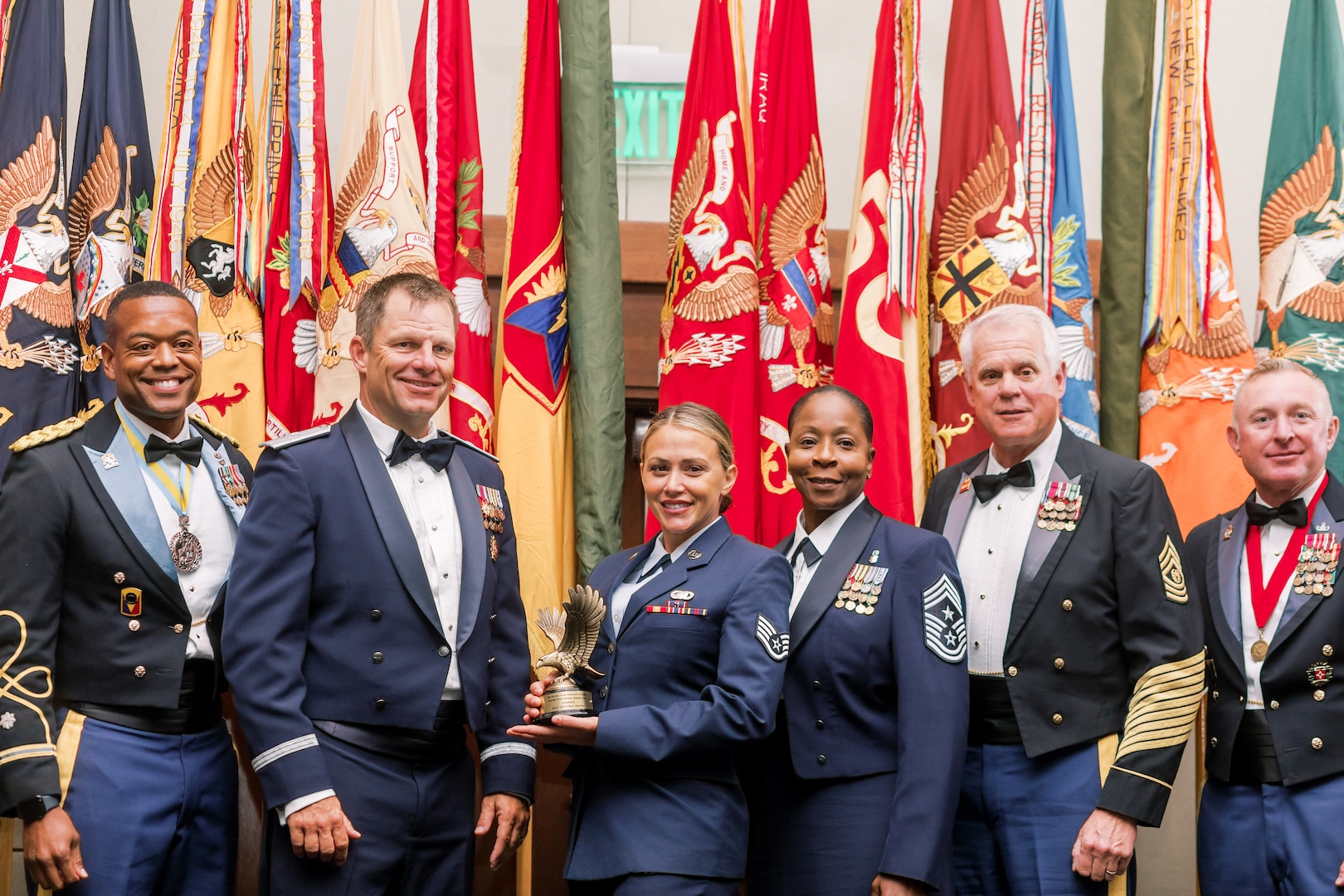 U.S. Air Force Staff Sgt. Victoria Truppo, 101st Air and Space Operations Group personnel specialist, middle, with leadership after she was awarded the 2024 Woody Braswell Heroism Award during the Adjutant General’s Leadership Summit in Orlando, Florida, June 28, 2024. Truppo rescued a mother and two children from drowning in powerful currents.