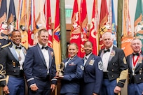 U.S. Air Force Staff Sgt. Victoria Truppo, 101st Air and Space Operations Group personnel specialist, middle, with leadership after she was awarded the 2024 Woody Braswell Heroism Award during the Adjutant General’s Leadership Summit in Orlando, Florida, June 28, 2024. Truppo rescued a mother and two children from drowning in powerful currents.
