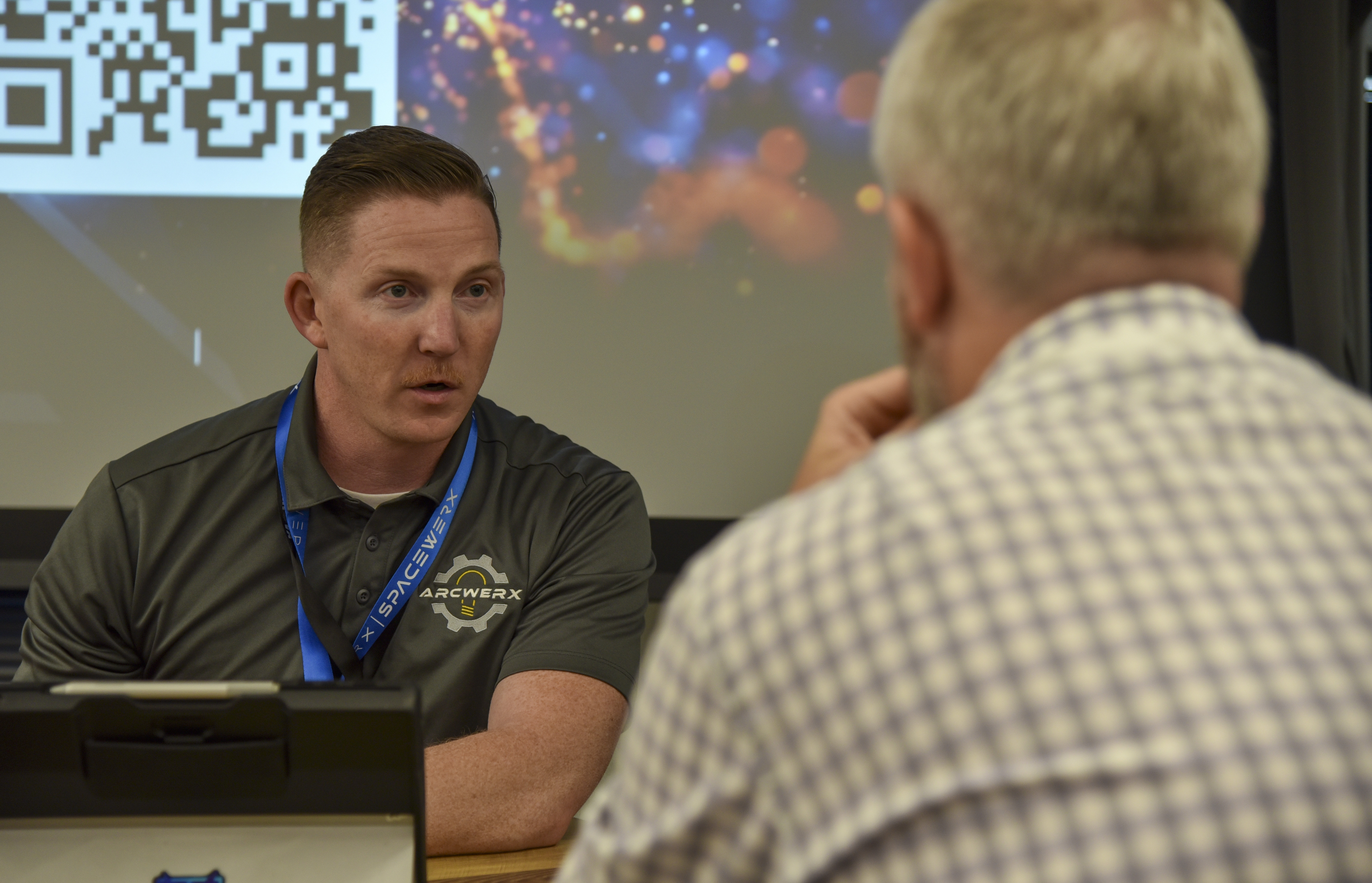 Tech. Sgt. Andy Barrick, ARCWERX innovation education lead, talks with industry during the Fed Supernova Challenge Showcase and Spark Collider event at Capital Factory in Austin, Texas, Aug. 20, 2024.