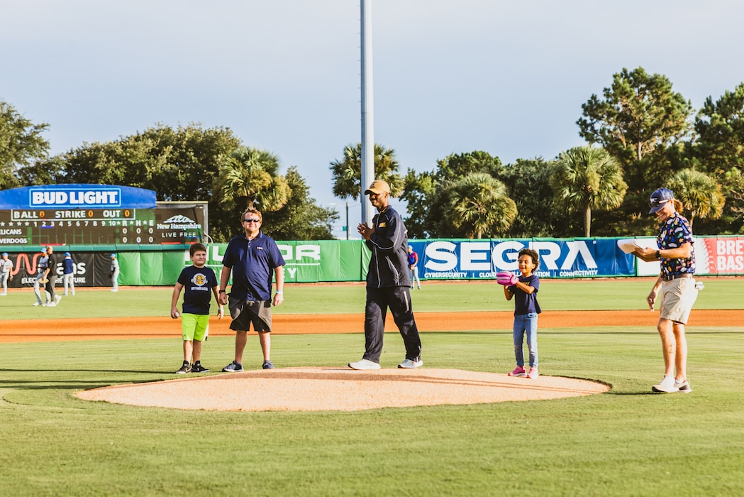 "NIWC Atlantic's new Commanding Officer CAPT Matt O'Neal recently threw out the first pitch at the Charleston RiverDogs Military Appreciation game on Aug. 22. This was the RiverDogs third appreciation game of the season" honoring active-duty service members, Veterans and their families. O'Neal, who assumed command of NIWC Atlantic last month, was recognized from the field as a local military leader. Go Dogs! (Photo by Emma Bair, Charleston RiverDogs Creative Media Intern