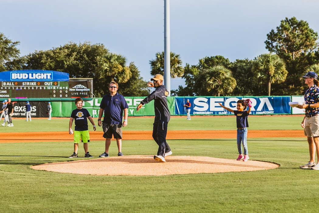 "NIWC Atlantic's new Commanding Officer CAPT Matt O'Neal recently threw out the first pitch at the Charleston RiverDogs Military Appreciation game on Aug. 22. This was the RiverDogs third appreciation game of the season" honoring active-duty service members, Veterans and their families. O'Neal, who assumed command of NIWC Atlantic last month, was recognized from the field as a local military leader. Go Dogs! (Photo by Emma Bair, Charleston RiverDogs Creative Media Intern