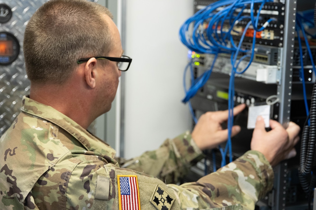 Chief Warrant Officer 3 Jeremy Jackson works on sattelite equipment in one of the Mobile Command Trailers. Soldiers from the Kentucky Army National Guard’s Communication/Information Technology Mission Command mobilized through parts of western Kentucky August 12-16 for a natural disaster response exercise. (U.S. Army National Guard Photo by Milt Spalding)