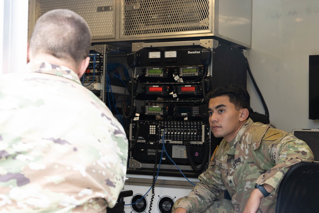 Chief Warrant Officer 3 Jeremy Jackson and Sgt. John Kutz discuss the mission in on of the Mobile Command Trailers. Soldiers from the Kentucky Army National Guard’s Communication/Information Technology Mission Command mobilized through parts of western Kentucky August 12-16 for a natural disaster response exercise. (U.S. Army National Guard Photo by Milt Spalding)