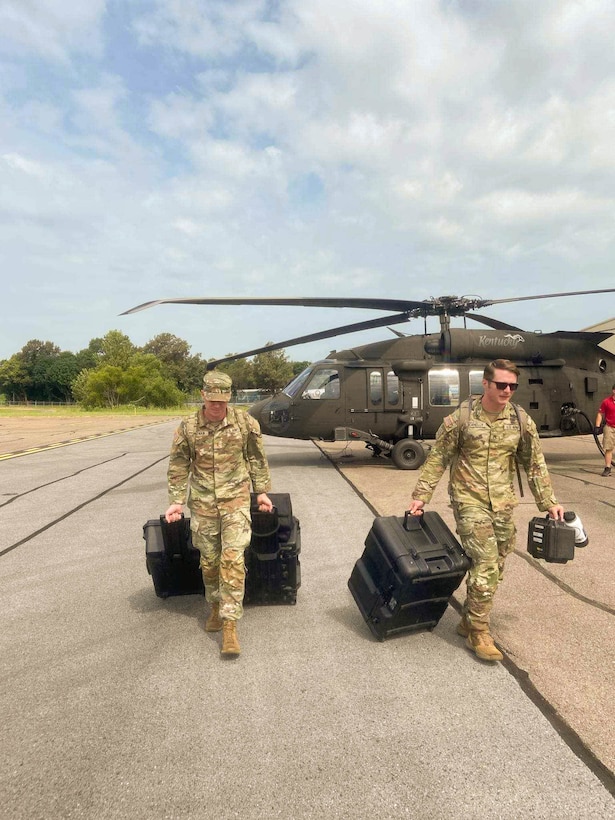 Soldiers carry communications equipment from a UH-60 Blackhawk helicopter in preparation for a mission. Soldiers from the Kentucky Army National Guard’s Communication/Information Technology Mission Command mobilized through parts of western Kentucky August 12-16 for a natural disaster response exercise. (U.S. Army National Guard Courtesy Asset)