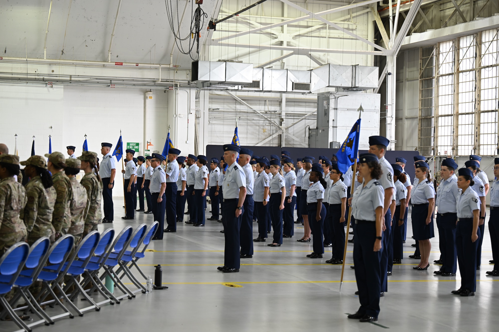 Air Force members stand at attention.