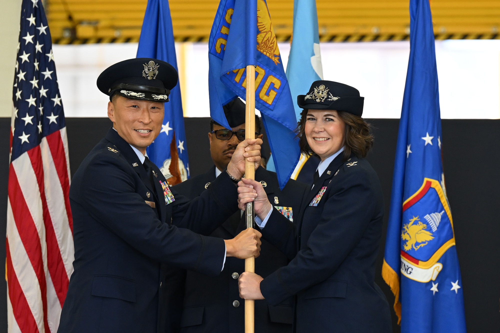 Military members hold guidon.
