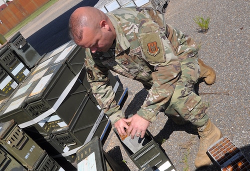 a man works on ammo cans