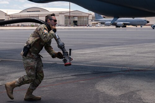 Air Force Master Sgt. Taj Copeland, Petroleum Oil and Lubricant operations supervisor assigned to the 927th Logistics Readiness Squadron, MacDiill Air Force Base, Florida, carries a fuel delivery hose to a KC-135 Stratotanker aircraft on Joint Base Pearl Harbor-Hickam, Hawaii, July 17, 2024, as part of Exercise Rim of the Pacific (RIMPAC) 2024. Twenty-nine nations, 40 surface ships, three submarines, 14 national land forces, more than 150 aircraft and 25,000 personnel are participating in RIMPAC in and around the Hawaiian Islands, June 27 to Aug. 1. The world's largest international maritime exercise, RIMPAC provides a unique training opportunity while fostering and sustaining cooperative relationships among participants critical to ensuring the safety of sea lanes and security on the world's oceans. RIMPAC 2024 is the 29th exercise in the series that began in 1971. (U.S. Air Force photo by Tech. Sgt. Bradley Tipton